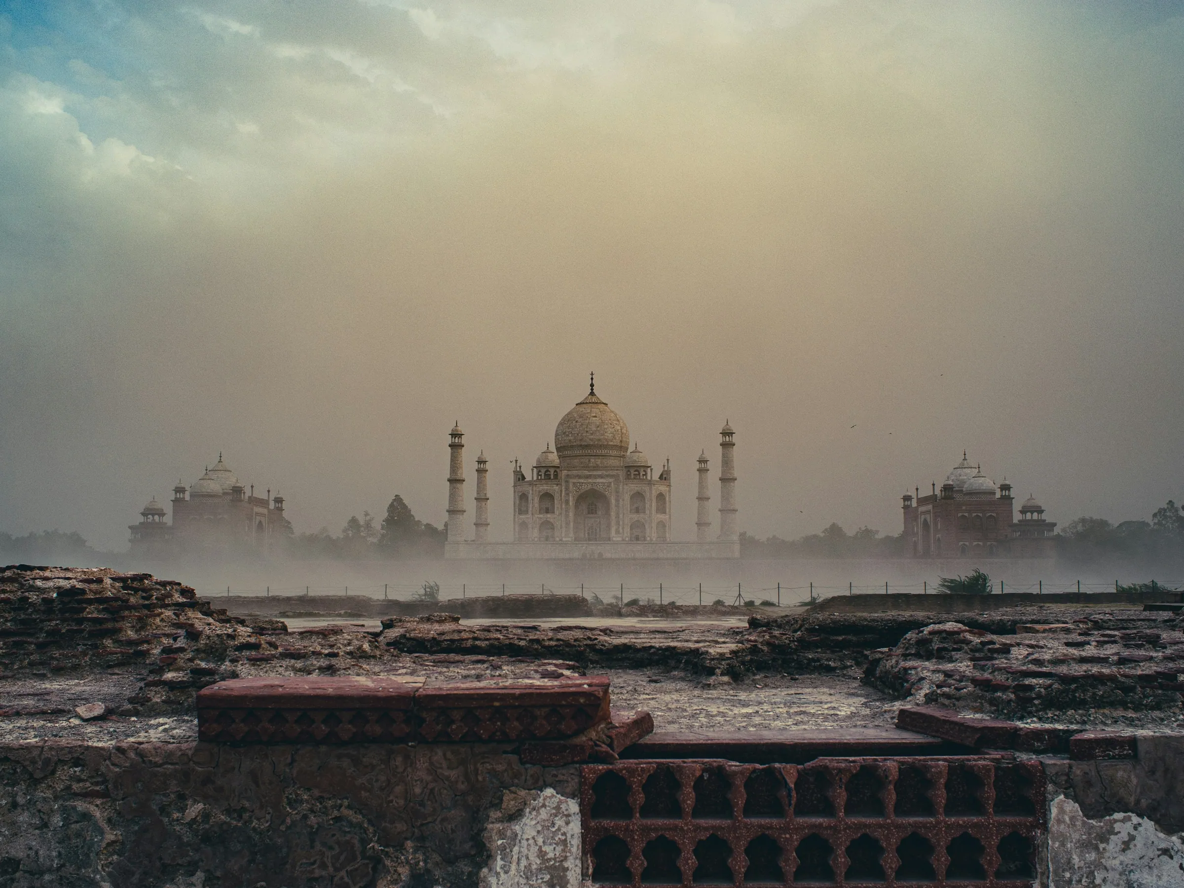 Das Taj Mahal im Dunst, hinter alten Ruinen gesehen