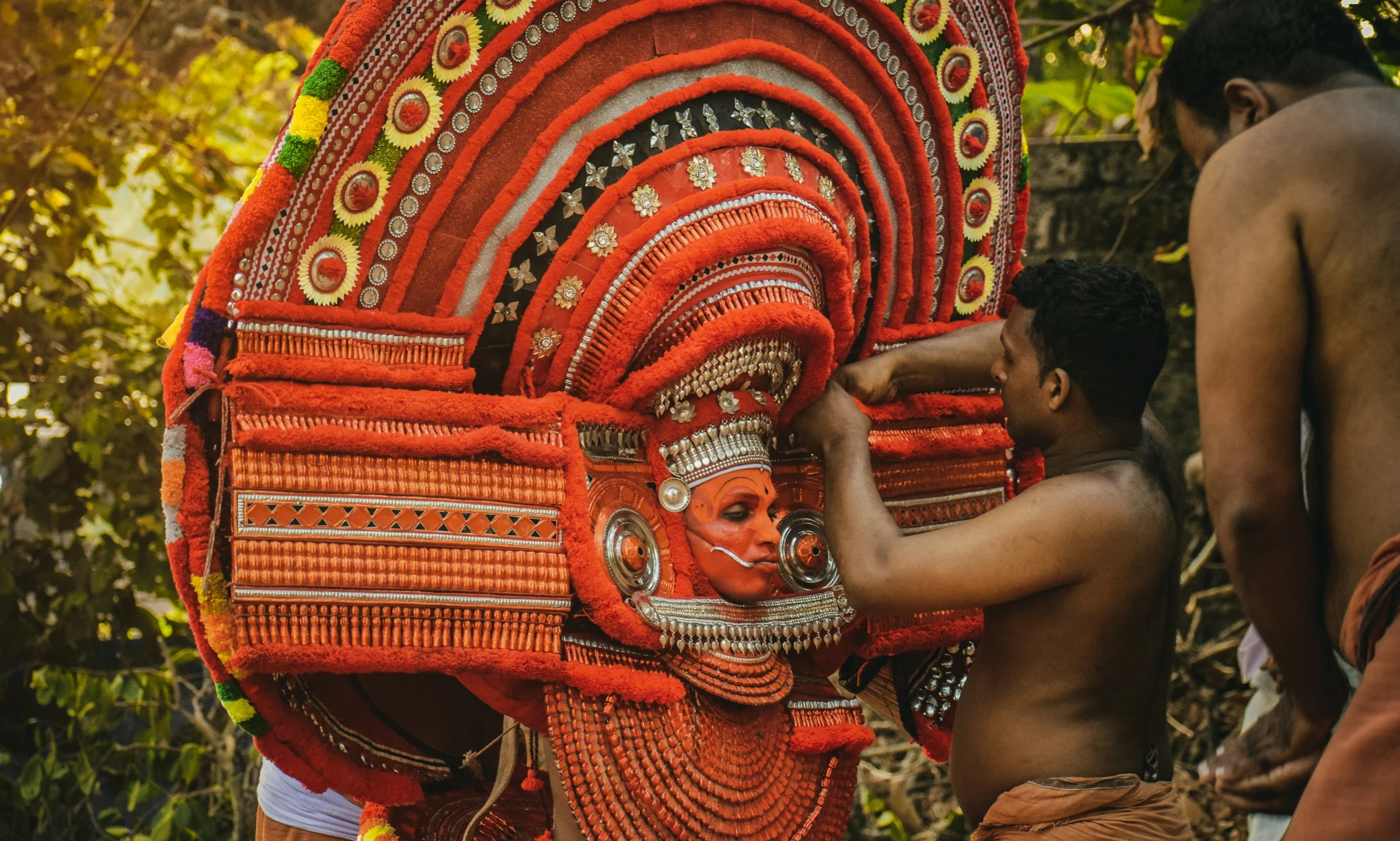 A Theyyam performer being made ready